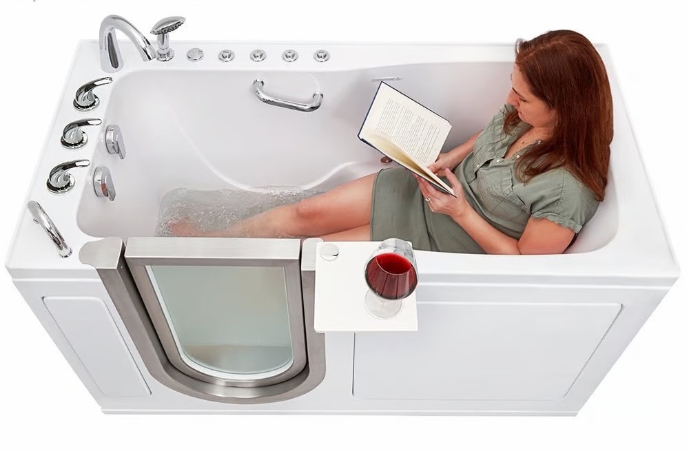 Woman reading a book and relaxing in a walk-in tub with a glass of wine